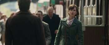 Movie still from “The Railway Man” (2013), directed by Jonathan Teplitzky – A group of people walking down a sidewalk; Medium shot, Over the shoulder angle