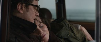 Movie still from “The Railway Man” (2013), directed by Jonathan Teplitzky – A man and a woman sitting close together; Close Up shot, High angle