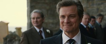 Movie still from “The Railway Man” (2013), directed by Jonathan Teplitzky – A man in a suit and tie standing next to another man in a suit and tie; Close Up shot, Over the shoulder angle