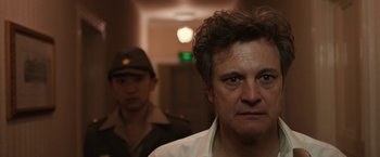 Movie still from “The Railway Man” (2013), directed by Jonathan Teplitzky – A man in a white shirt and a man in a green hat; Close Up shot, Low angle