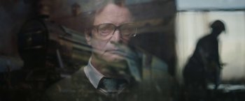 Movie still from “The Railway Man” (2013), directed by Jonathan Teplitzky – A man wearing glasses looking out a window; Close Up shot, Low angle