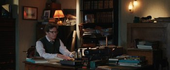 Movie still from “The Railway Man” (2013), directed by Jonathan Teplitzky – A man sitting at a desk in front of a computer; Medium shot, Over the shoulder angle