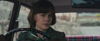 Movie still from “The Railway Man” (2013), directed by Jonathan Teplitzky – A woman sitting in the driver's seat of a car; Close Up shot, Over the shoulder angle