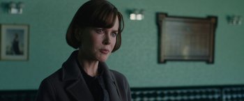 Movie still from “The Railway Man” (2013), directed by Jonathan Teplitzky – A woman in a black jacket is standing in a room; Close Up shot, Over the shoulder angle