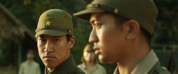 Movie still from “The Railway Man” (2013), directed by Jonathan Teplitzky – A group of men in green uniforms and hats; Close Up shot, Over the shoulder angle