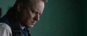 Movie still from “The Railway Man” (2013), directed by Jonathan Teplitzky – A person looking down at his face; Close Up shot, Low angle