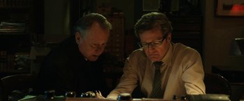 Movie still from “The Railway Man” (2013), directed by Jonathan Teplitzky – Two men looking at a piece of paper on top of a table; Close Up shot, Low angle