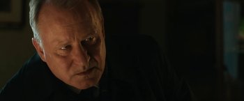 Movie still from “The Railway Man” (2013), directed by Jonathan Teplitzky – An older man with a serious look on his face; Close Up shot, Over the shoulder angle