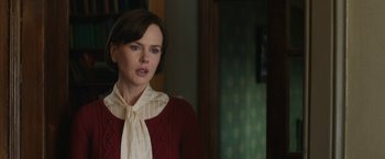 Movie still from “The Railway Man” (2013), directed by Jonathan Teplitzky – A woman in a red sweater and a white neck tie; Close Up shot, Over the shoulder angle