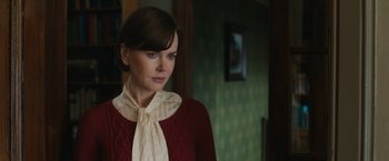 Movie still from “The Railway Man” (2013), directed by Jonathan Teplitzky – A woman in a red sweater and a white neck tie; Close Up shot, Over the shoulder angle