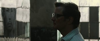 Movie still from “The Railway Man” (2013), directed by Jonathan Teplitzky – A person wearing glasses and a plaid shirt; Close Up shot, Low angle
