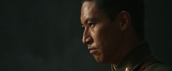 Movie still from “The Railway Man” (2013), directed by Jonathan Teplitzky – A man's face in a dark room; Close Up shot, Low angle