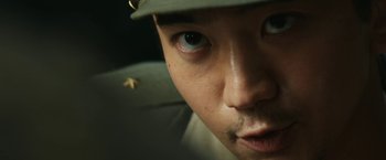 Movie still from “The Railway Man” (2013), directed by Jonathan Teplitzky – A man's face with a hat on; Extreme Close Up shot, Low angle