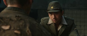 Movie still from “The Railway Man” (2013), directed by Jonathan Teplitzky – A man wearing a uniform with a star on his hat; Close Up shot, Over the shoulder angle