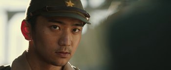 Movie still from “The Railway Man” (2013), directed by Jonathan Teplitzky – A person wearing a hat; Close Up shot, Over the shoulder angle