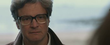 Movie still from “The Railway Man” (2013), directed by Jonathan Teplitzky – A person wearing glasses and a jacket; Close Up shot, Low angle