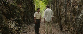 Movie still from “The Railway Man” (2013), directed by Jonathan Teplitzky – Two men standing on a path in the woods talking; Wide shot, Over the shoulder angle
