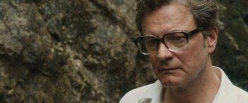 Movie still from “The Railway Man” (2013), directed by Jonathan Teplitzky – A person wearing glasses near a rock wall; Close Up shot, High angle