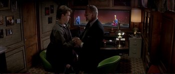 Movie still from “The Rainmaker” (1997), directed by Francis Ford Coppola – A man and a young boy in a room; Medium shot, Over the shoulder angle