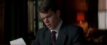 Movie still from “The Rainmaker” (1997), directed by Francis Ford Coppola – A man in a suit and tie looking down; Close Up shot, Low angle