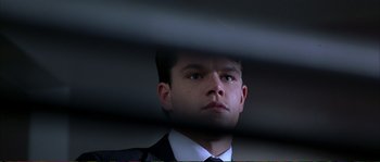 Movie still from “The Rainmaker” (1997), directed by Francis Ford Coppola – A person wearing a suit and tie; Close Up shot, Low angle