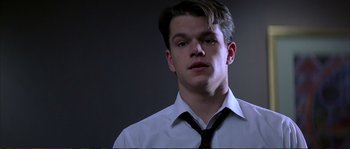 Movie still from “The Rainmaker” (1997), directed by Francis Ford Coppola – A man in a white shirt and a red neck tie; Close Up shot, Low angle