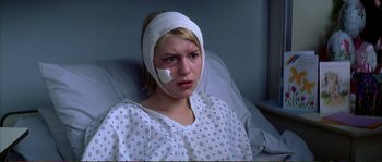 Movie still from “The Rainmaker” (1997), directed by Francis Ford Coppola – A woman with bandages on her head in a hospital bed; Close Up shot, High angle