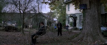 Movie still from “The Rainmaker” (1997), directed by Francis Ford Coppola – A group of people standing in a yard; Extreme Wide shot, High angle