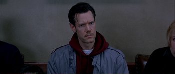Movie still from “The Rainmaker” (1997), directed by Francis Ford Coppola – A person wearing a jacket and a scarf; Close Up shot, High angle