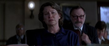 Movie still from “The Rainmaker” (1997), directed by Francis Ford Coppola – An older woman is sitting in front of a man; Close Up shot, Over the shoulder angle