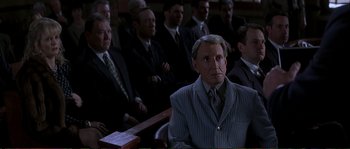 Movie still from “The Rainmaker” (1997), directed by Francis Ford Coppola – A group of men sitting in front of each other in a courtroom; Medium shot, High angle