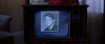 Movie still from “The Rainmaker” (1997), directed by Francis Ford Coppola – An old tv with a picture of a man on the screen; Extreme Close Up shot, Low angle