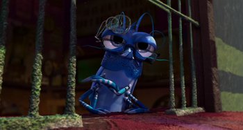 Movie still from “Shark Tale” (2004), directed by Vicky Jenson – A blue bug with glasses sitting in a forest; Close Up shot, High angle