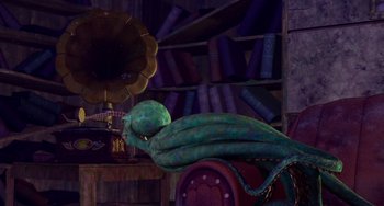 Movie still from “Shark Tale” (2004), directed by Vicky Jenson – A green snake laying on top of an old record player; Wide shot, High angle
