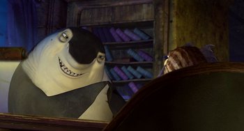 Movie still from “Shark Tale” (2004), directed by Vicky Jenson – A cat looking at a stuffed animal; Medium shot, High angle