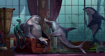 Movie still from “Shark Tale” (2004), directed by Vicky Jenson – A couple of sea animals that are sitting in a chair; Wide shot, High angle