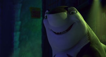 Movie still from “Shark Tale” (2004), directed by Vicky Jenson – A smiling shark in a dark room; Close Up shot, Low angle