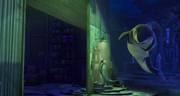 Movie still from “Shark Tale” (2004), directed by Vicky Jenson – An image of an animated scene with a person and a shark; Wide shot, Low angle