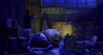 Movie still from “Shark Tale” (2004), directed by Vicky Jenson – A large stuffed animal sitting on top of a pile of boxes; Wide shot, High angle