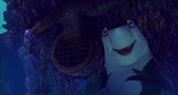 Movie still from “Shark Tale” (2004), directed by Vicky Jenson – A shark's head in the dark; Medium shot, Overhead angle