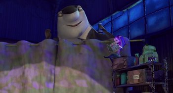Movie still from “Shark Tale” (2004), directed by Vicky Jenson – A shark is standing in a room next to a suitcase; Wide shot, Low angle