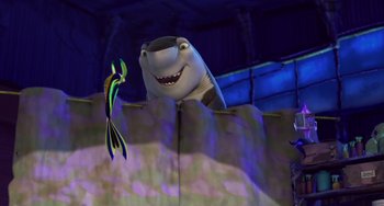 Movie still from “Shark Tale” (2004), directed by Vicky Jenson – A shark and a fish in the shape of a wall; Medium shot, Over the shoulder angle