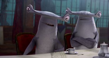 Movie still from “Shark Tale” (2004), directed by Vicky Jenson – A couple of sharks sitting at a dinner table; Medium shot, High angle