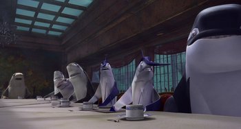 Movie still from “Shark Tale” (2004), directed by Vicky Jenson – A group of sharks sitting at a dinner table; Wide shot, High angle