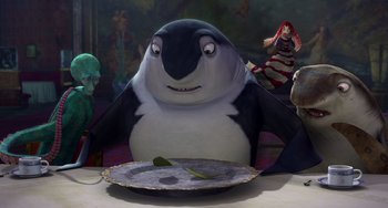 Movie still from “Shark Tale” (2004), directed by Vicky Jenson – A penguin sitting in front of a plate on a table; Medium shot, High angle