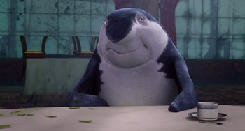 Movie still from “Shark Tale” (2004), directed by Vicky Jenson – A stuffed penguin sitting at a table in front of a window; Medium shot, High angle