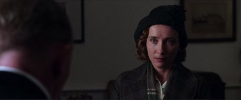 Movie still from “The Remains of the Day” (1993), directed by James Ivory – A woman wearing a black hat and a jacket; Close Up shot, Over the shoulder angle