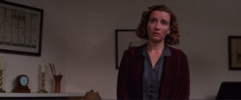 Movie still from “The Remains of the Day” (1993), directed by James Ivory – A woman standing in front of a wall looking up; Medium shot, Low angle