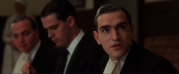 Movie still from “The Remains of the Day” (1993), directed by James Ivory – A man in a suit and tie next to another man in a suit and tie; Close Up shot, Low angle