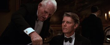 Movie still from “The Remains of the Day” (1993), directed by James Ivory – Two men in tuxedos looking at each other; Close Up shot, Over the shoulder angle